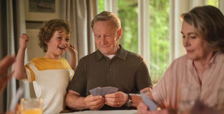 Patient and wife playing cards. Actor portrayal